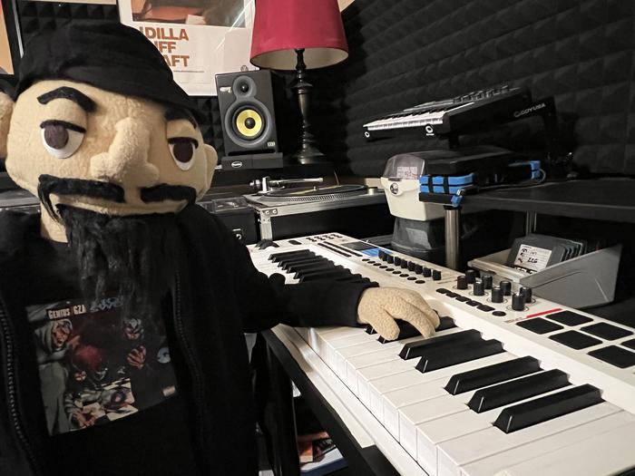 Puppet character playing a MIDI keyboard in the studio