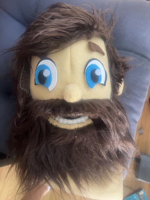 Close-up of a puppet character's face with beard detail