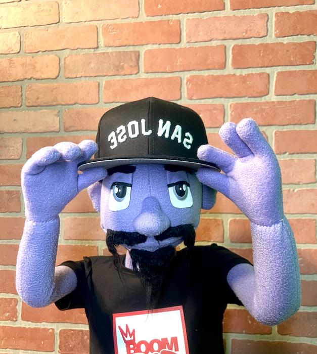 Puppet character holding the brim of a San Jose cap