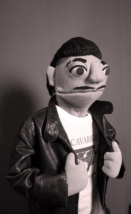 Puppet character in a leather jacket, sepia toned photo