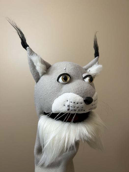 Grey lynx-style puppet head with tufted ears and whiskers