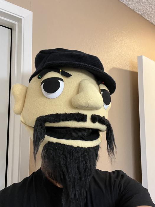 Puppet head in progress with beard, front view with pins